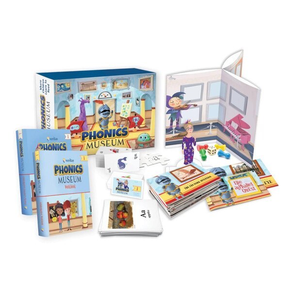 The Phonics Museum First Grade Kit contents, including the teacher's manual, workbook, game cards, primers, and playing pieces.