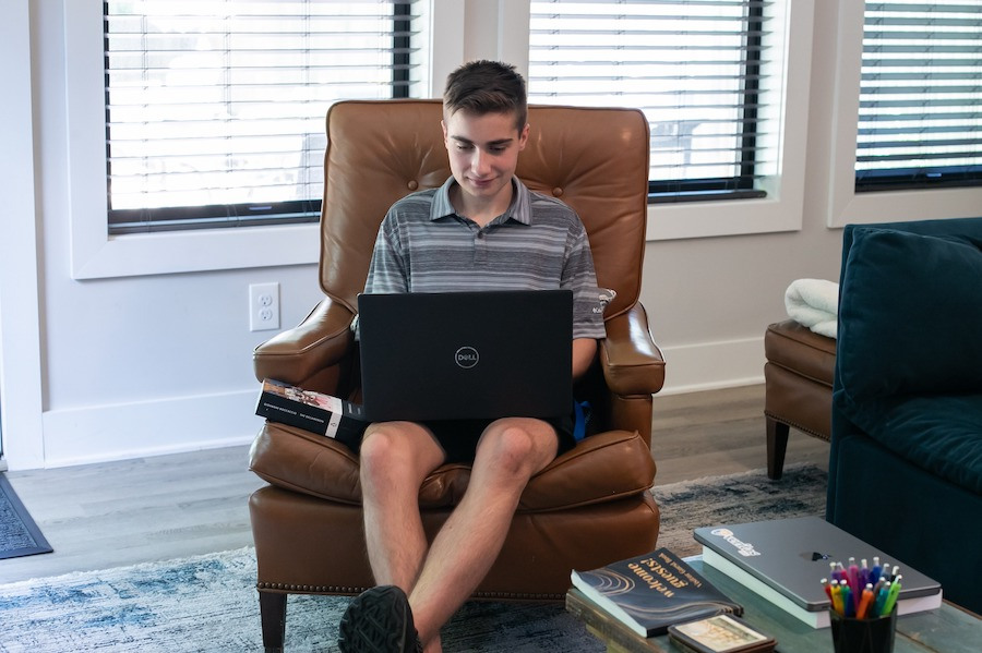 Veritas Scholars Academy A student learns in a live online classroom on his laptop.