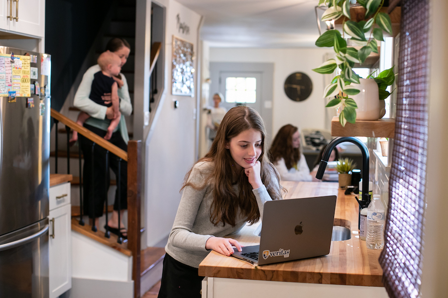 Veritas Scholars Academy Student experiences live teaching with family in the background